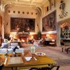 Luxurious historic living room with elegant decor, tapestries, and ornate ceiling in traditional English manor house