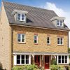 Modern semi-detached brick house with double doors and dormer windows in a green suburban area