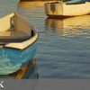 Two boats on a calm Norfolk waterway at sunset inviting visitors to explore the scenic beauty and tranquillity of the area