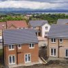 Aerial view of new residential homes in a suburban UK neighbourhood with modern architecture and landscaped gardens