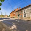Street view of traditional English village with brick and stone buildings under a clear blue sky