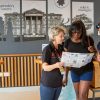 Group receiving information at a National Trust location desk in the UK
