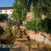 Charming historic mill surrounded by lush greenery and a tranquil waterway in the English countryside