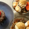Delicious chocolate dessert with strawberries and bowls of ice cream topped with toasted marshmallows and crumbs