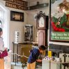 Visitors exploring historical museum exhibits with vintage signs and collectibles