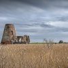 Ancient stone tower in a rural field under a cloudy sky in Britain landscape photo