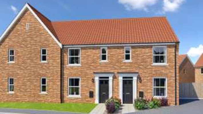 Modern semi-detached brick house with red roof and tidy garden in a UK neighbourhood under blue sky