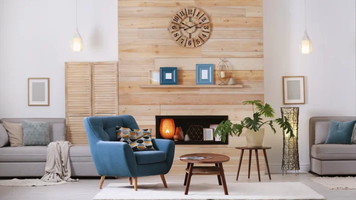 Modern living room with blue chair, wooden accents, coffee table, stylish decor, and soft lighting for a cosy ambience